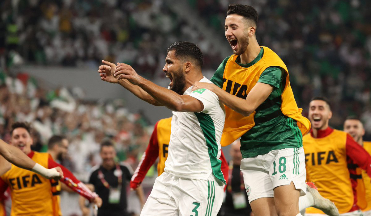 Algeria players celebrate with fans after the match